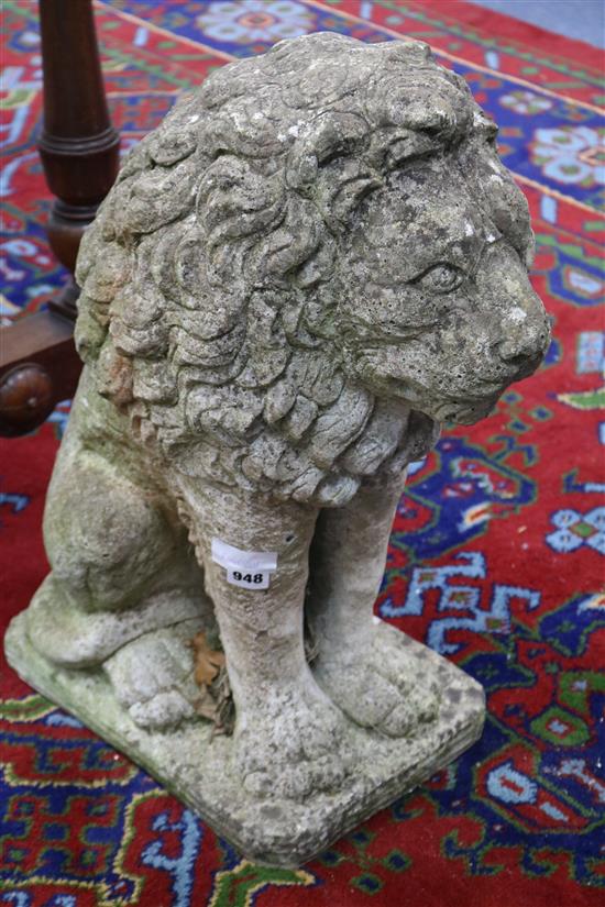 A weathered composition garden statue modelled as a seated lion, H.2ft